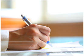 hand with pen writing on paper